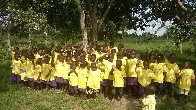Group of children wearing yellow uniforms outdoors
